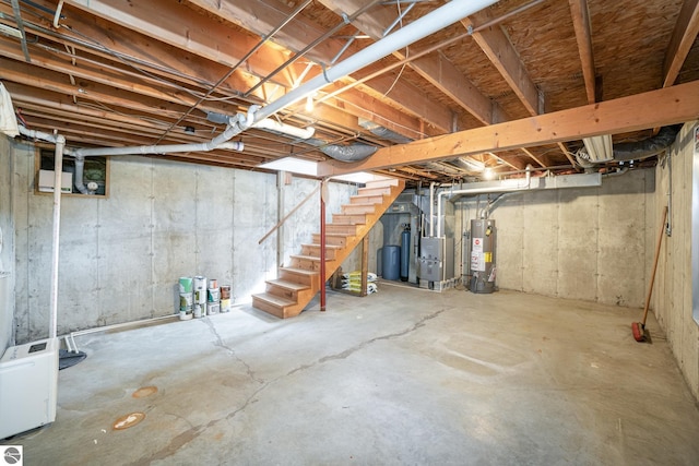 unfinished below grade area with water heater, stairway, and heating unit
