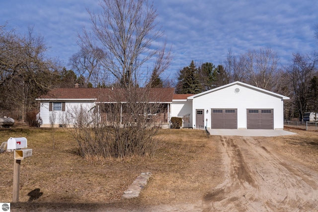 ranch-style home with an attached garage and driveway