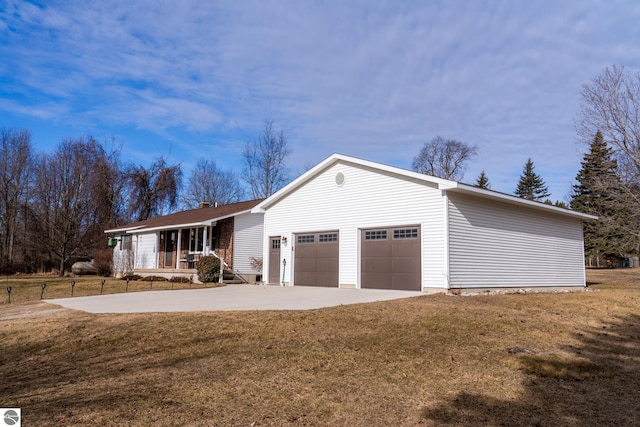 ranch-style house with a front yard, concrete driveway, covered porch, and an attached garage