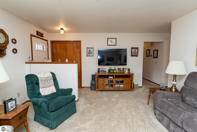 carpeted living room featuring baseboards