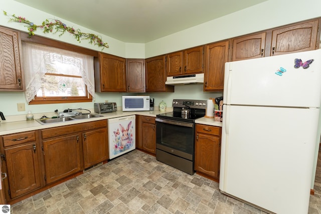 kitchen featuring under cabinet range hood, white appliances, light countertops, and a sink