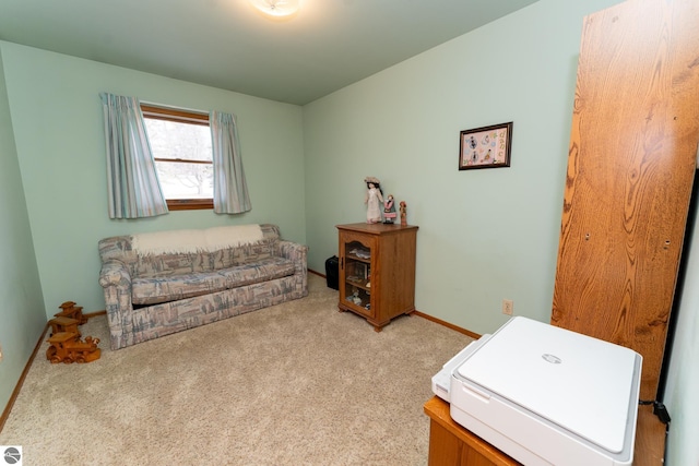 office with baseboards and light carpet