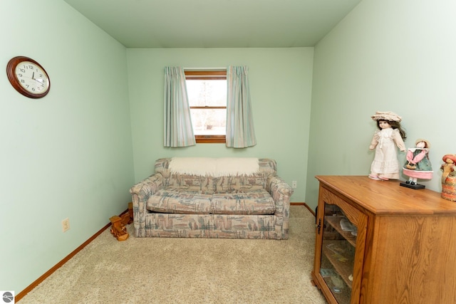 living area with baseboards and carpet