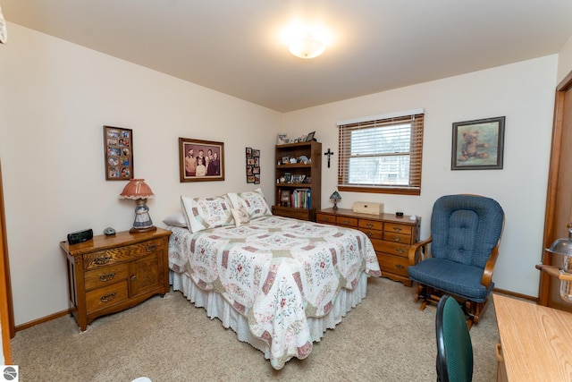 bedroom featuring baseboards and light carpet