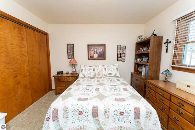 carpeted bedroom with a closet