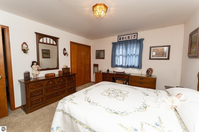 bedroom with light carpet and a closet