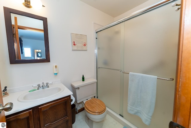 bathroom with a shower with door, toilet, and vanity