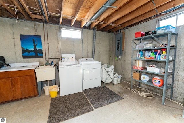 clothes washing area with laundry area, electric panel, and separate washer and dryer