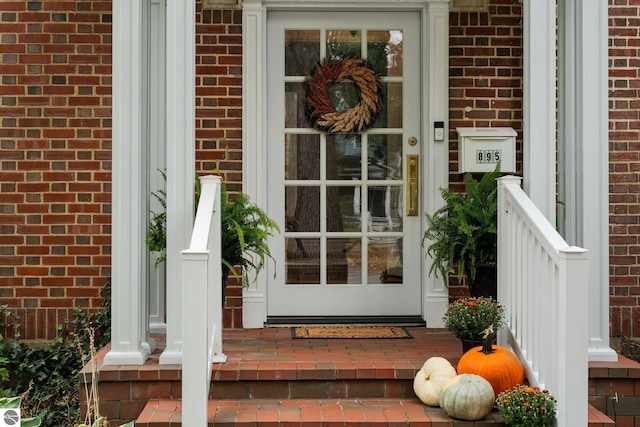 property entrance featuring brick siding