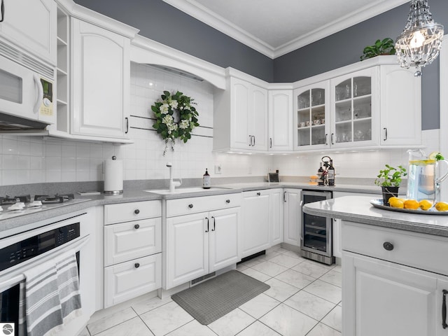 kitchen featuring white cabinetry, white appliances, wine cooler, and ornamental molding