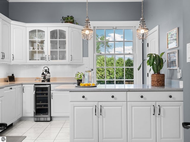 kitchen featuring glass insert cabinets, wine cooler, backsplash, and white cabinets