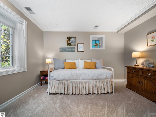 bedroom featuring visible vents, baseboards, crown molding, and carpet