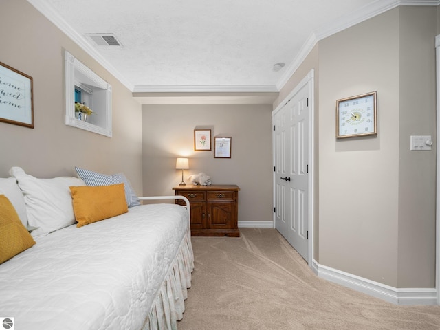 bedroom with baseboards, visible vents, a closet, crown molding, and light colored carpet