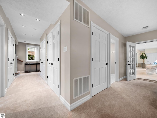 corridor featuring visible vents, recessed lighting, and carpet floors