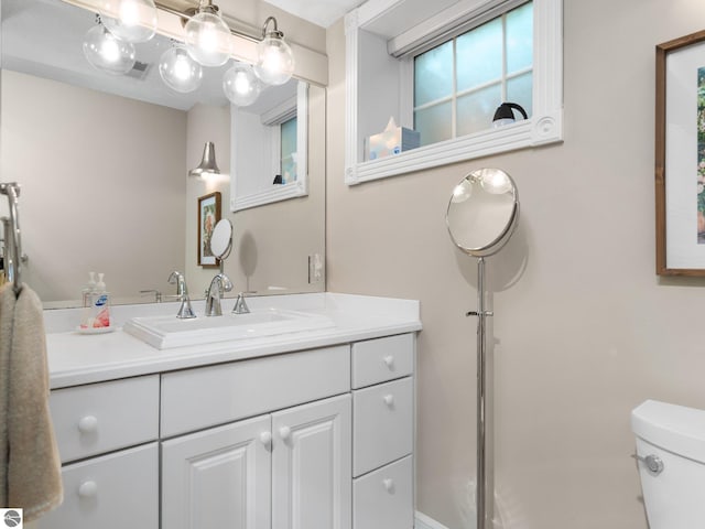 bathroom featuring vanity and toilet