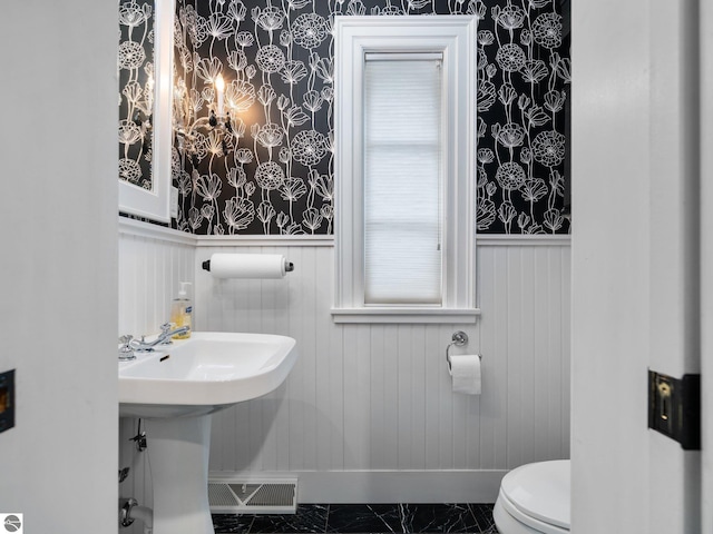 bathroom featuring visible vents, wallpapered walls, a wainscoted wall, toilet, and marble finish floor