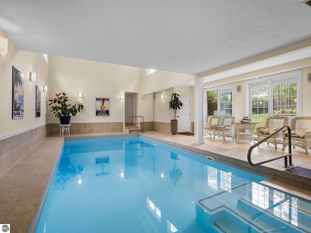 indoor pool featuring ornate columns