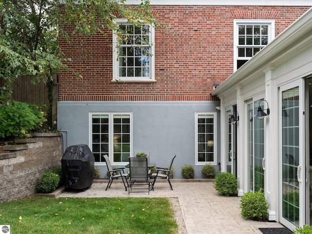 view of patio with area for grilling and fence