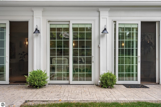 view of exterior entry featuring a patio