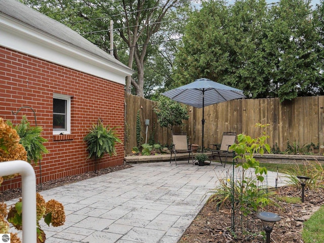 view of patio / terrace featuring fence