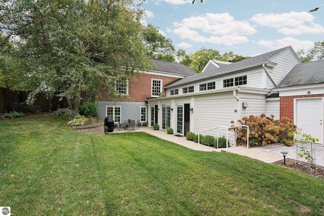 back of house featuring brick siding, a patio, a yard, and fence