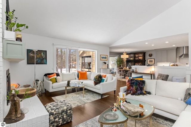 living area featuring recessed lighting, lofted ceiling, and wood finished floors