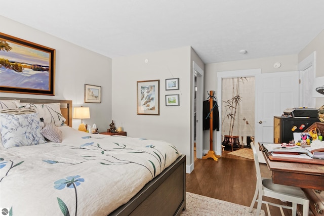 bedroom with wood finished floors and baseboards