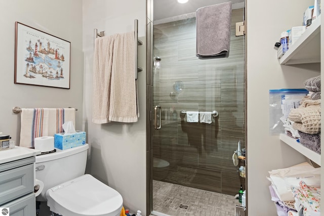 full bathroom featuring vanity, toilet, and a shower stall