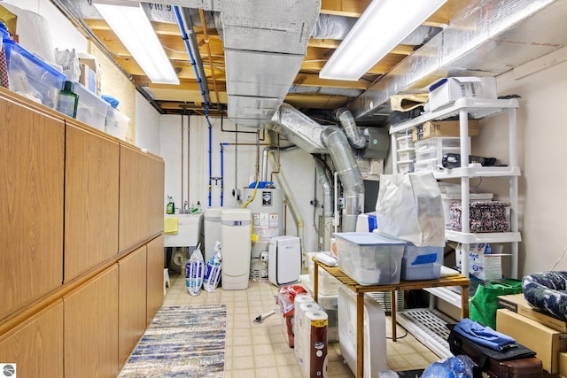 unfinished below grade area featuring gas water heater, tile patterned floors, and a sink