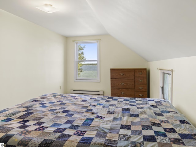 unfurnished bedroom with vaulted ceiling and a baseboard radiator