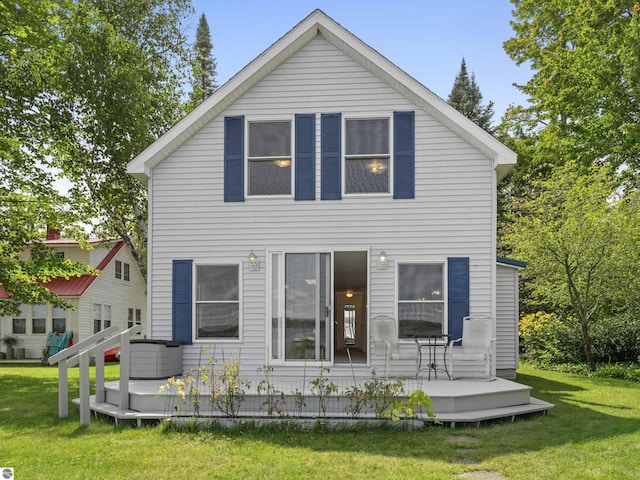 view of front of house with a wooden deck and a front yard