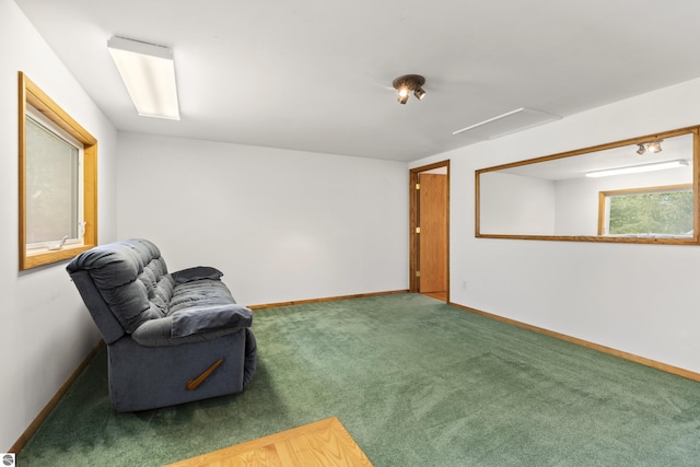 living area featuring baseboards and carpet flooring