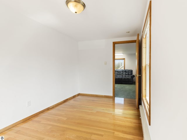 empty room featuring light wood-style flooring and baseboards