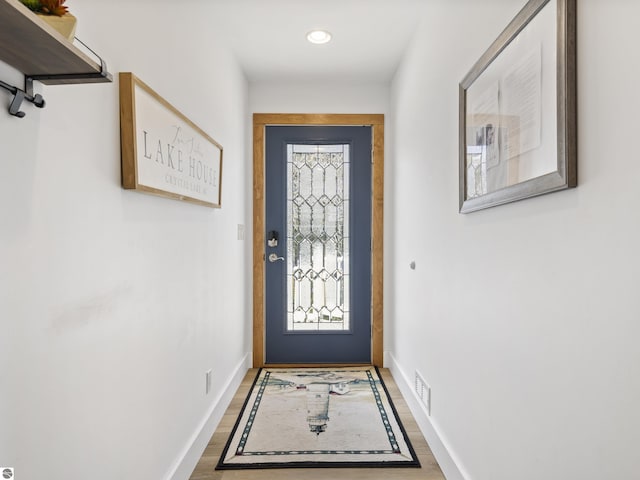 doorway to outside featuring a wealth of natural light, baseboards, wood finished floors, and recessed lighting