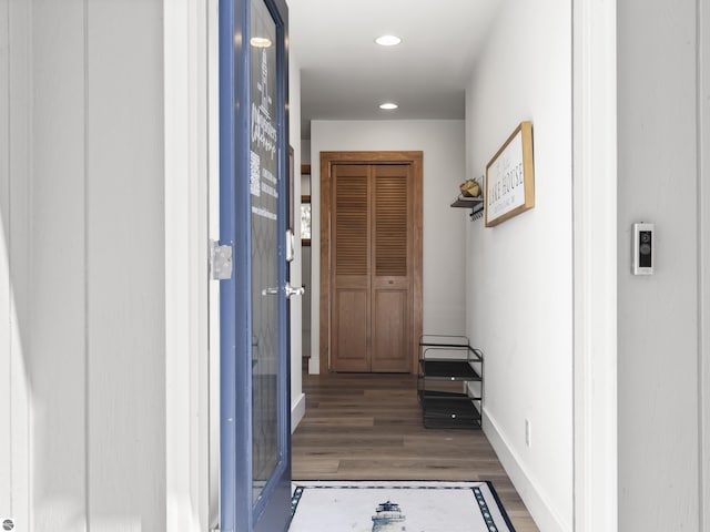 hall featuring recessed lighting, baseboards, and wood finished floors