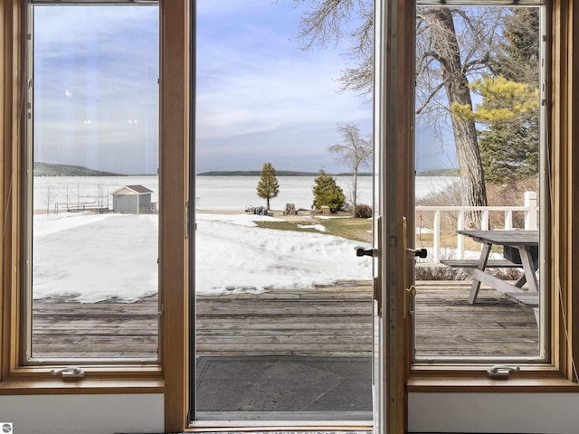 doorway with a healthy amount of sunlight and a water view