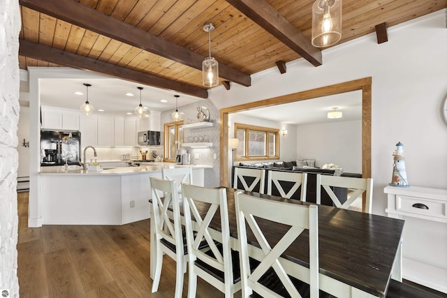 dining room featuring beam ceiling, baseboard heating, wood ceiling, and dark wood-style flooring