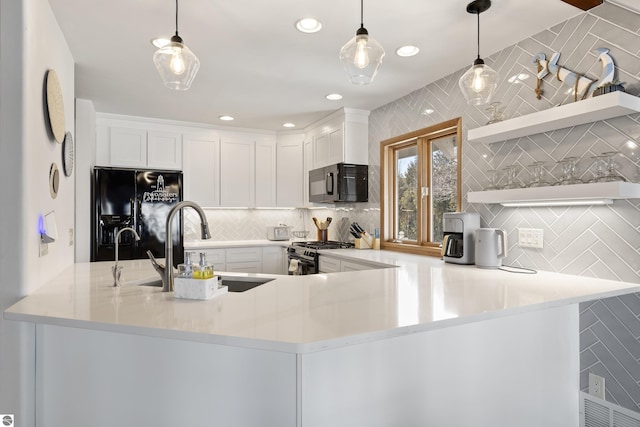 kitchen featuring a peninsula, open shelves, a sink, black appliances, and backsplash