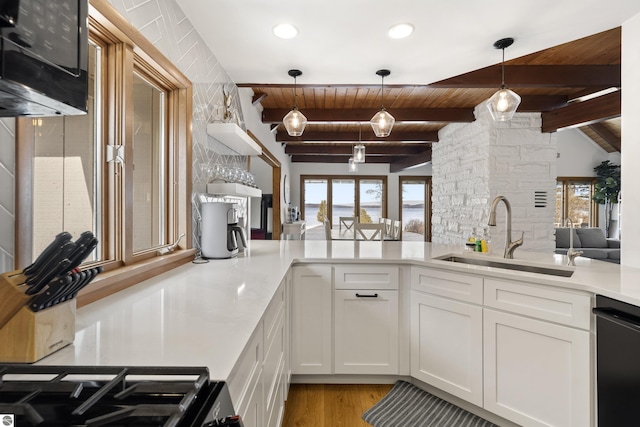 kitchen featuring a sink, light countertops, black dishwasher, white cabinetry, and wooden ceiling