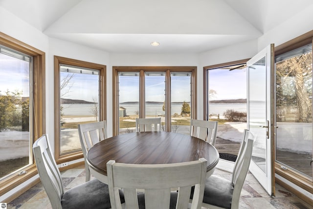 dining area with recessed lighting, visible vents, lofted ceiling, and stone tile floors