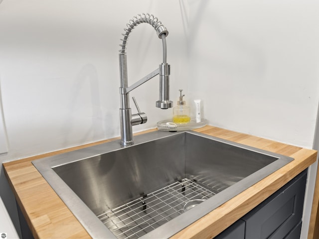 interior details featuring butcher block countertops and a sink