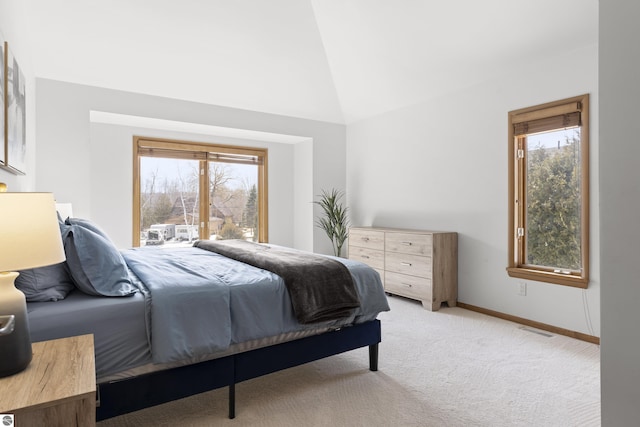 bedroom featuring baseboards, visible vents, light carpet, and lofted ceiling