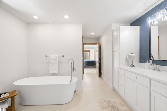 bathroom with recessed lighting, connected bathroom, a soaking tub, and vanity