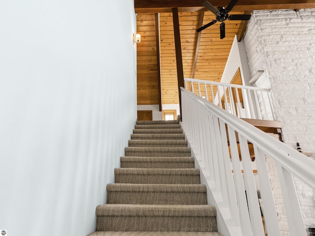 stairway with wood ceiling, a ceiling fan, and beamed ceiling