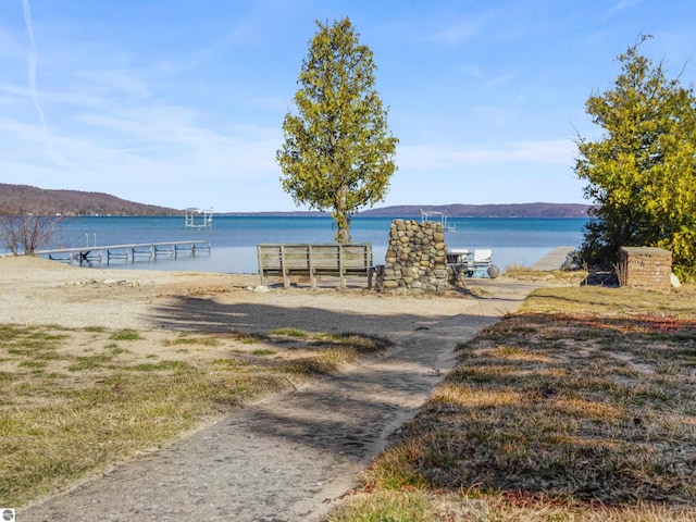 view of water feature with a mountain view and a dock