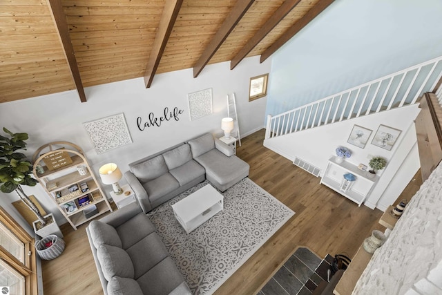 living room with wood finished floors, visible vents, lofted ceiling with beams, stairs, and wooden ceiling