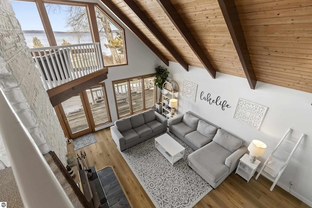 living room with wood finished floors, beam ceiling, high vaulted ceiling, and wooden ceiling