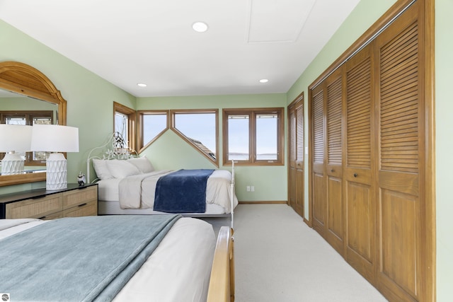 bedroom featuring a closet, recessed lighting, baseboards, and carpet floors