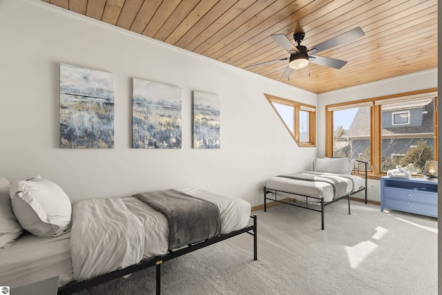 bedroom featuring baseboards, a ceiling fan, wood ceiling, and carpet flooring