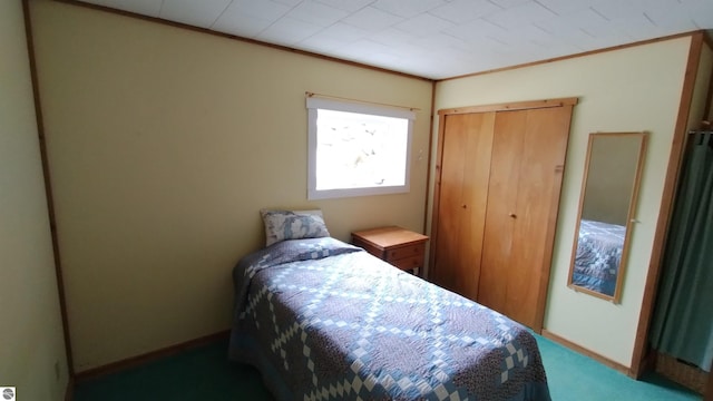 bedroom with a closet, baseboards, and ornamental molding